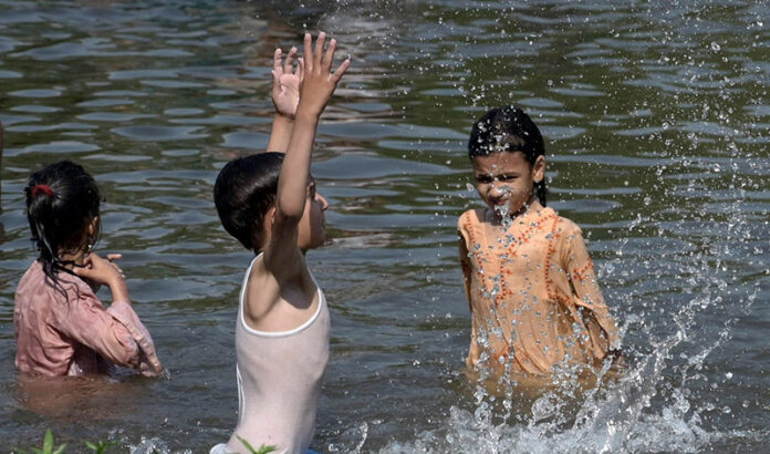 Children splashing and swimming in Korang Stream near Chak Shahzad, seeking relief from the extreme heat wave hit the federal capital as the temperature soared 42°C in federal capital