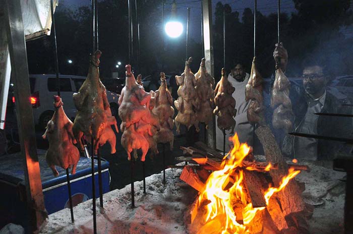 A vendor making chicken Saiji at outside a local hotel.