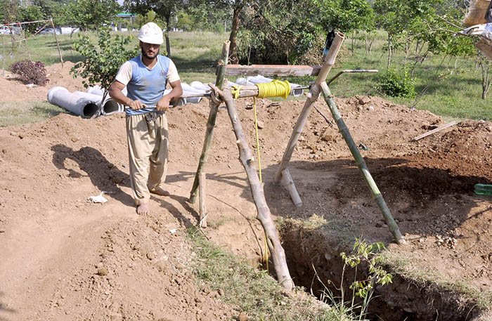 Laborers are excavating the ground to install new RCC pipe lines at the F-6 Sector.